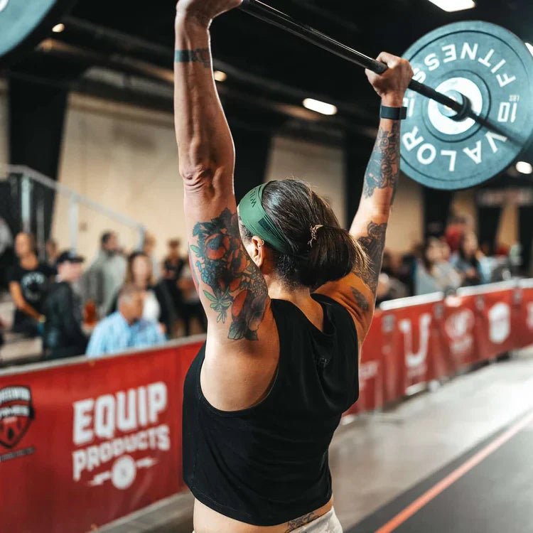 A CrossFit competitor lifting a barbell with 10lbs on each side.