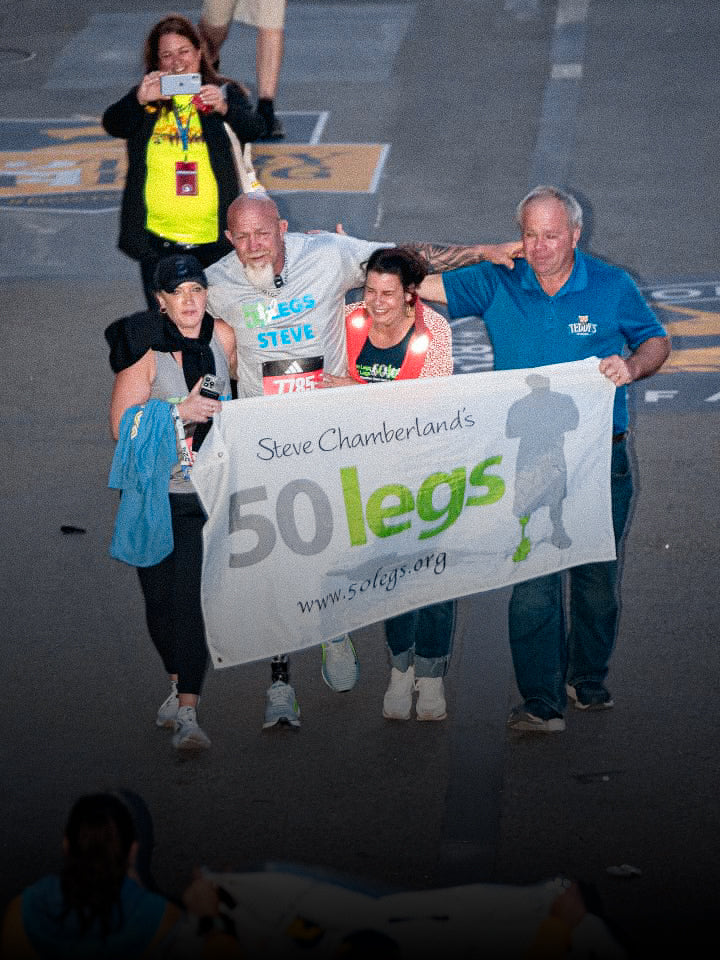 50 Legs Founder Steve Chamberland crossing the finish line in the 128th Boston Marathon.