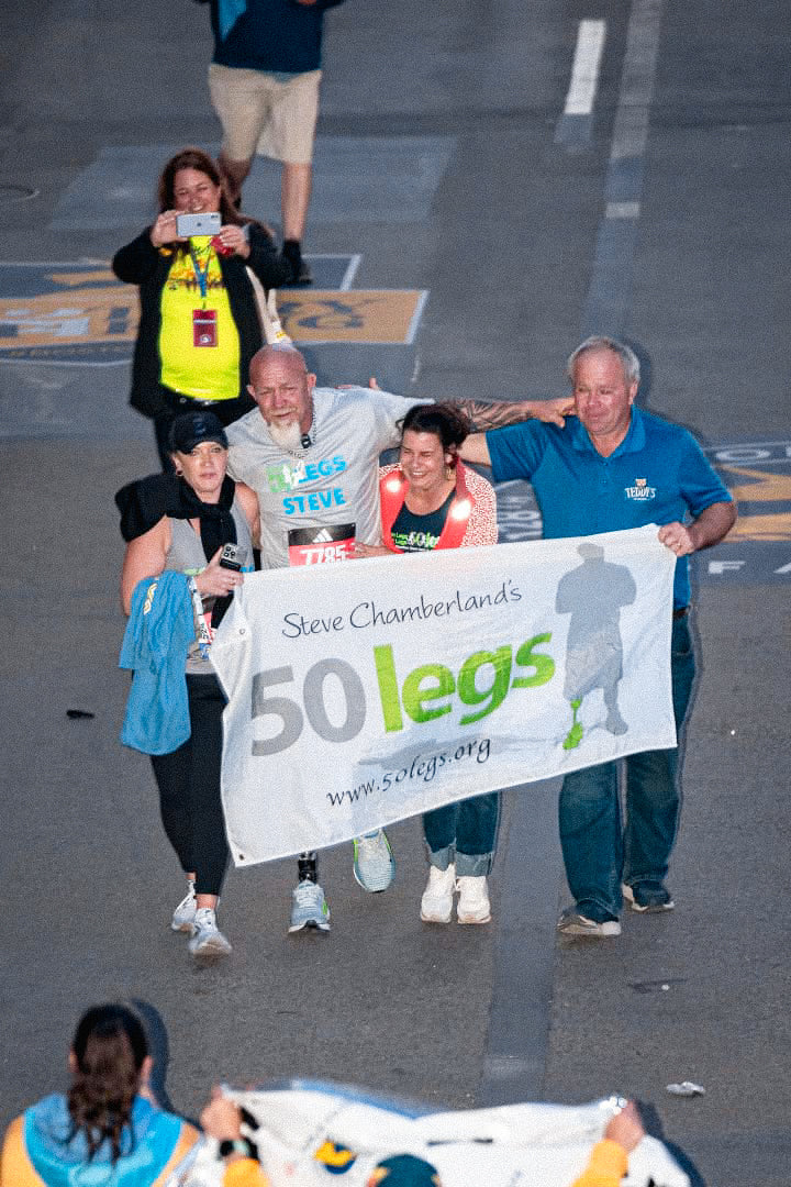 50 Legs Founder Steve Chamberland crossing the finish line in the 128th Boston Marathon.