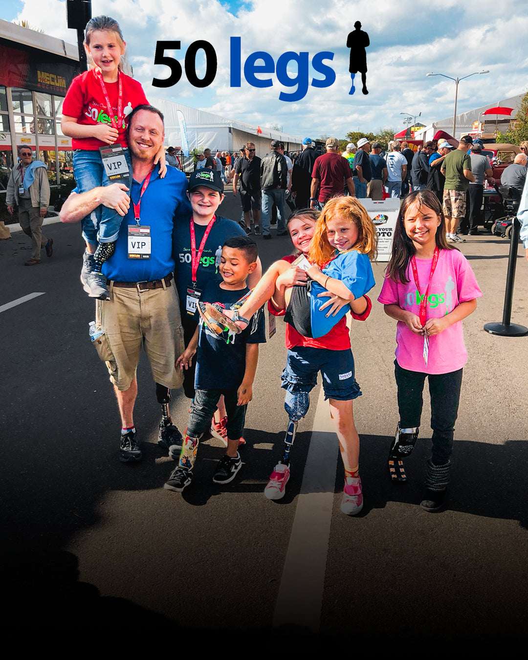 50 Legs group photo of adult and kid prosthetic recipients at the Mecum Auction.