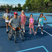 Group portrait of Cincinnati Tennis Foundation beginner adaptive spring tennis participants and coach.