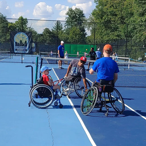 Cincinnati Tennis Foundation beginner adaptive spring tennis participant and coaches playing on the court.