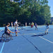 Cincinnati Tennis Foundation beginner adaptive spring tennis participants and coaches playing on the court.