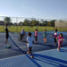 Cincinnati Tennis Foundation beginner adaptive spring tennis participants and coach playing on the court.