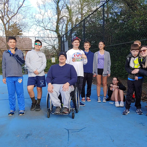 Group portrait of Cincinnati Tennis Foundation beginner adaptive spring tennis participants and coach.