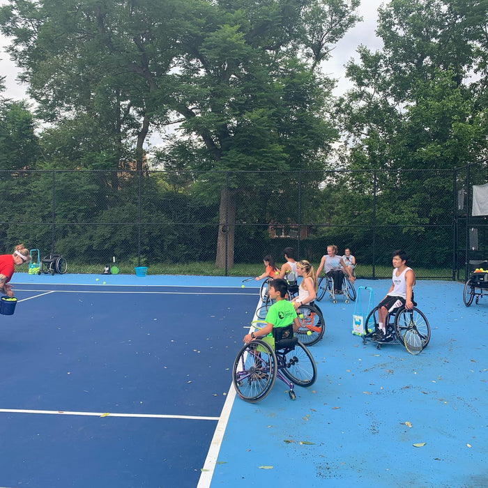 Cincinnati Tennis Foundation advanced wheelchair tennis participants getting ready to return serves.