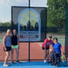 Group portait of a Cincinnati Tennis Foundation advanced wheelchair tennis participant and coaches.