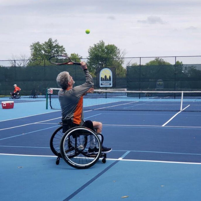 A Cincinnati Tennis Foundation advanced wheelchair tennis participant  getting ready to serve.