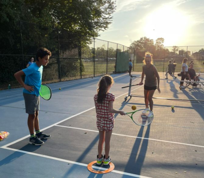 A Cincinnati Tennis Foundation Blind & Visually Impaired tennis participant  getting ready to serve.