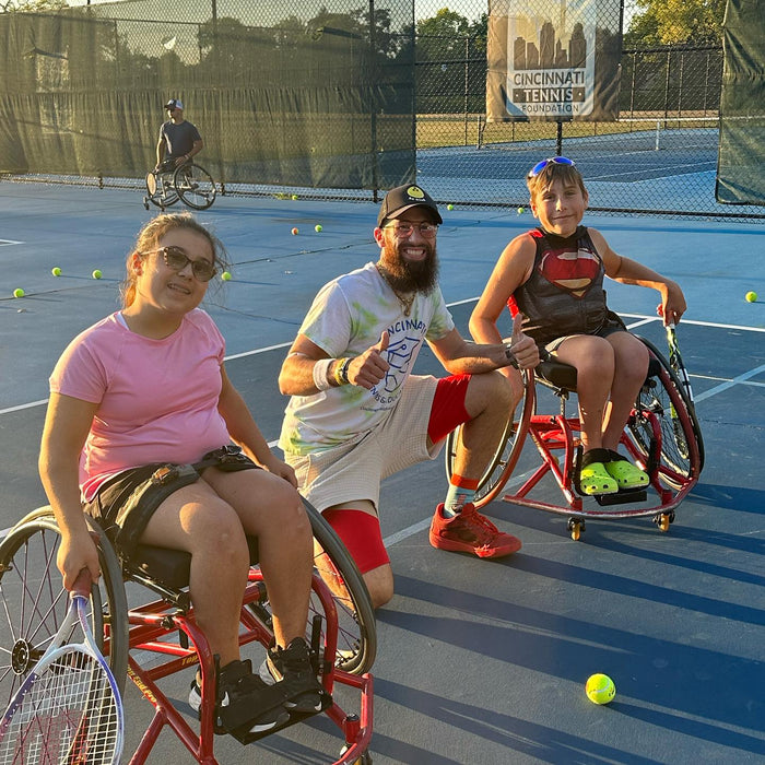 Group portrait of Cincinnati Tennis Foundation intro to wheelchair tennis participants and coach.