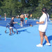 Cincinnati Tennis Foundation intro to para-standing participant returning a serve with their coach.