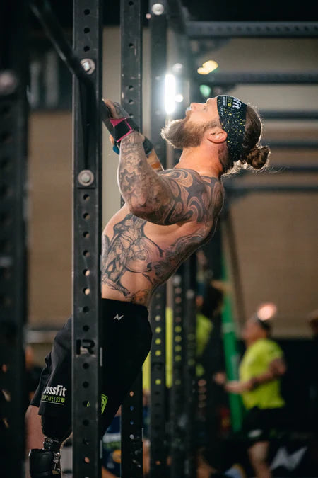 A left above knee amputee pulling up in a CrossFit competition.