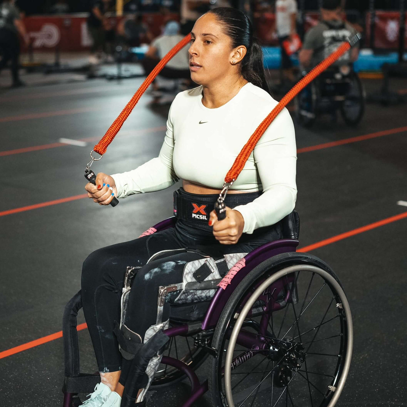 A person using a wheelchair with their Multi Ropes™ in a gym.