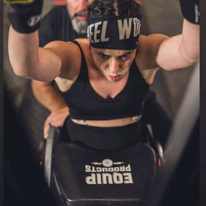 Equip Products Black Small LapMat™ in use during a CrossFit competition with a competitor in a wheelchair using a ski machine.