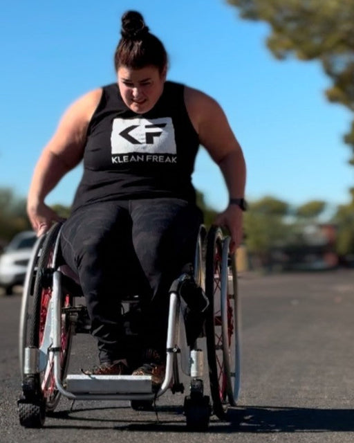 NorCal SCI's Coach Steph Roach pushing her wheelchair as a workout.