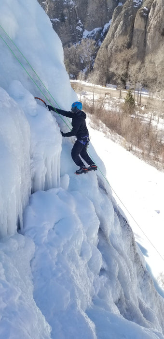 A Paradox Sports climber ascending the icewall at the Lake City Ice Skills 201.