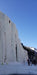 Paradox Sports climber ascending the icewall at the Lake City Ice Skills 201 with a line of climbers at the base.