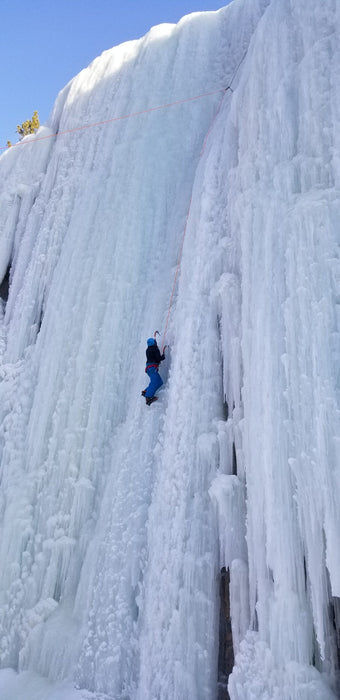 A Paradox Sports climber ascending the icewall at the Lake City Ice Skills 201.