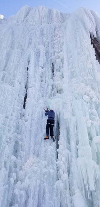 A Paradox Sports climber ascending the icewall at the Lake City Ice Skills 201.