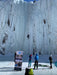 Paradox Sports climbers ascending with a Paradox Sports banner at the base of the Lake City Ice Skills 201.