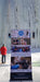 Paradox Sports banner at the base of the Lake City Ice Skills 201 with Paradox Sports climbers ascending the icewall.