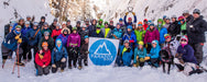 Group of Paradox Sports climbers holding the Paradox Sports Flag at the Ouray Ice Trip.