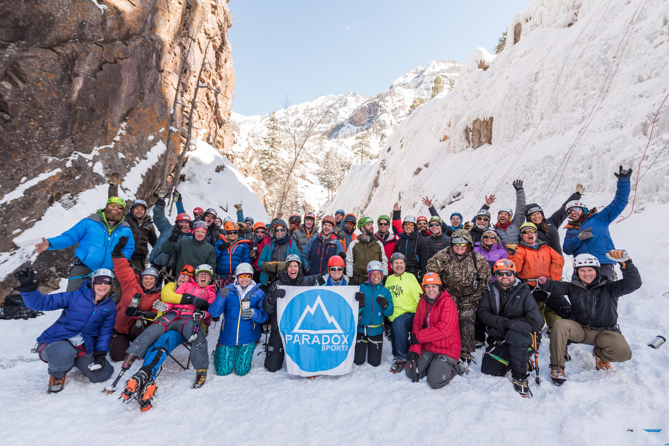 Group of Paradox Sports climbers holding the Paradox Sports Flag at the Ouray Ice Trip.