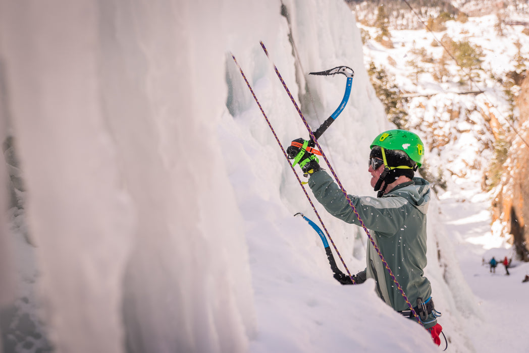 A Paradox Sports climber about to put their ice pick into the icewall at the Ouray Ice Trip.