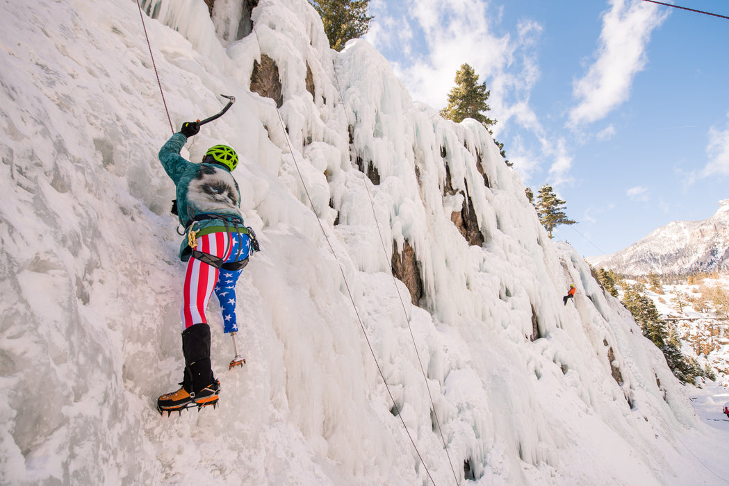 Behind a Paradox Sports climber about to put their ice pick into the icewall at the Ouray Ice Trip with.